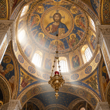 Painted Byzantine dome and hanging lamp inside a church